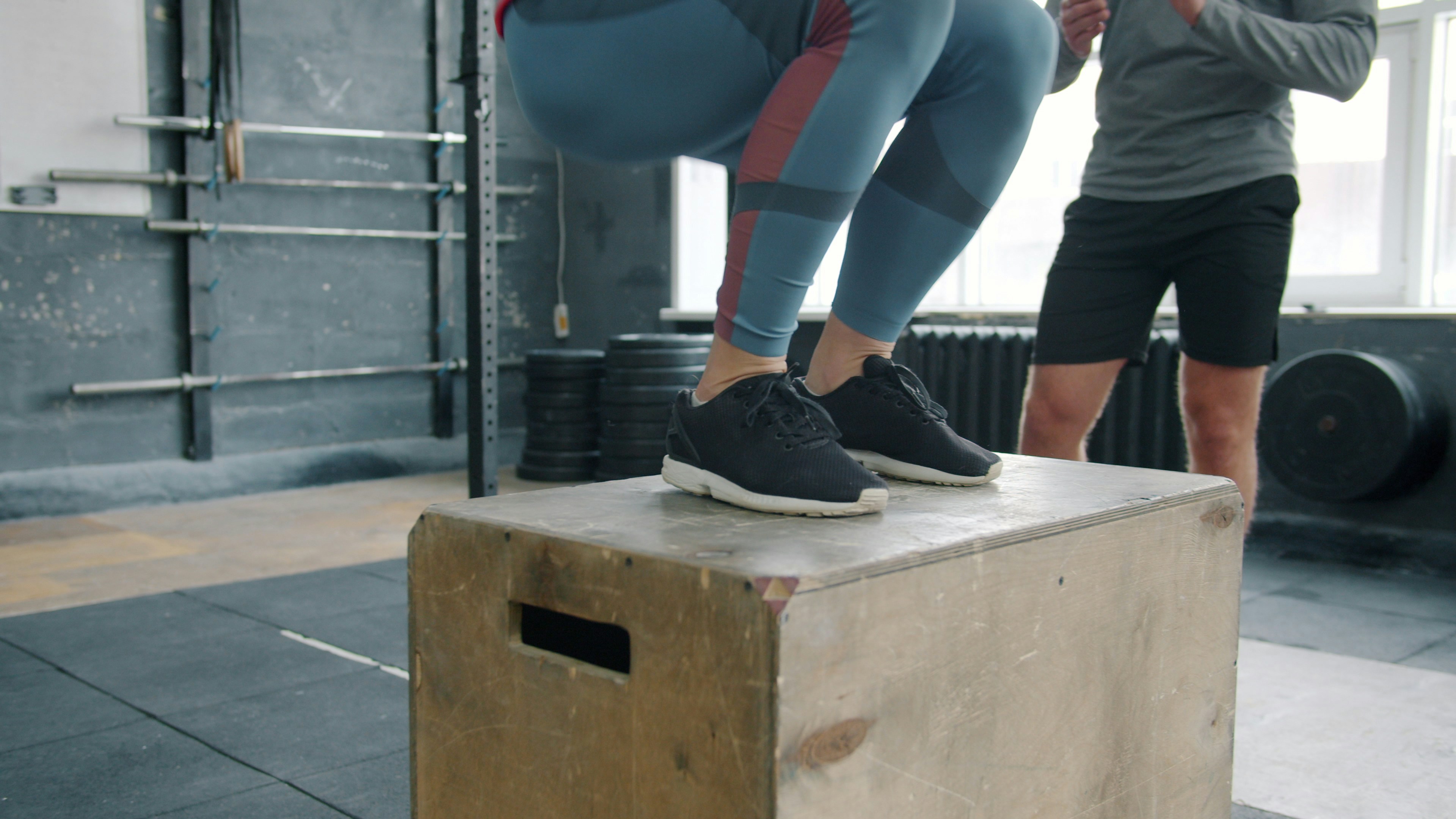 Athlete jumping onto a wooden box during plyometric training